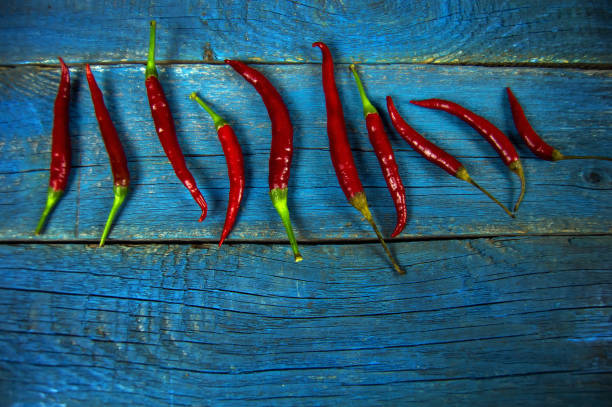 red bitter pepper on an old wooden background stock photo