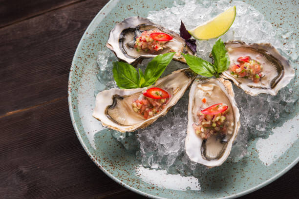 istock Open oyster stuffed with papper and lemon 1035986004