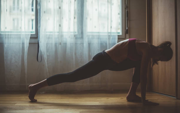 istock Woman exercising at home 1035991906