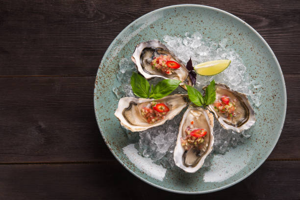 istock Open oyster stuffed with papper and lemon 1035992592