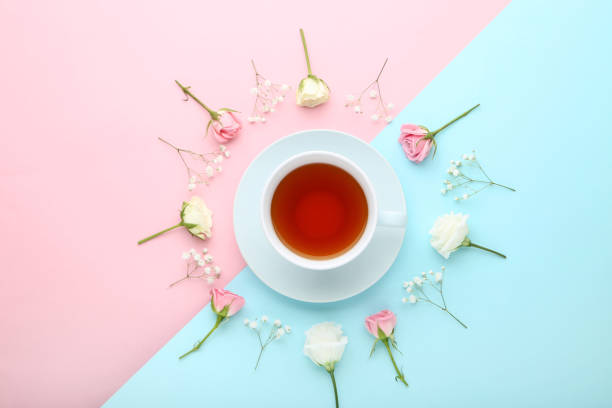 istock Flowers with cup of tea on colorful background 1035995200