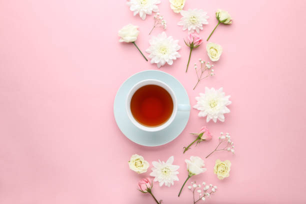 istock Flowers with cup of tea on pink background 1035995292