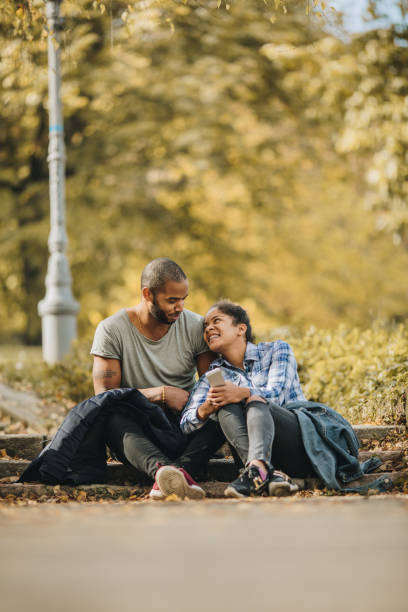 istock Smiling African American couple communicating in the park. 1036002412