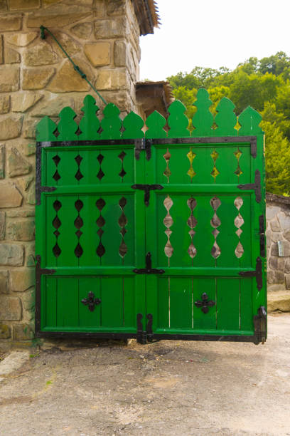 istock old rustic wood gate painted in green with masive metal hinges 1036003516