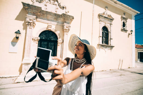 istock Beautiful tourist enjoying vacations, taking selfie 1036006668