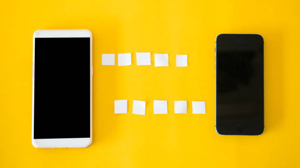 istock smartphone connect Office desk table Top view yellow background paper cut style 1036010274