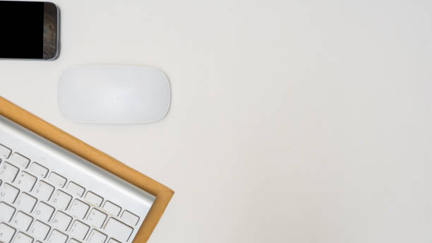 istock Office desk table with smart phone, mouse, keyboard,Envelope,Top view with  copy space 1036010332