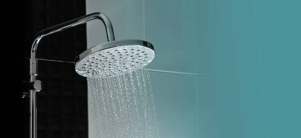 Close up of Water flowing from shower Close up of Water flowing from shower in the bathroom interior shower head stock pictures, royalty-free photos & images