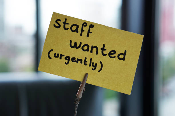 Staff wanted urgently written on a memo at the office stock photo