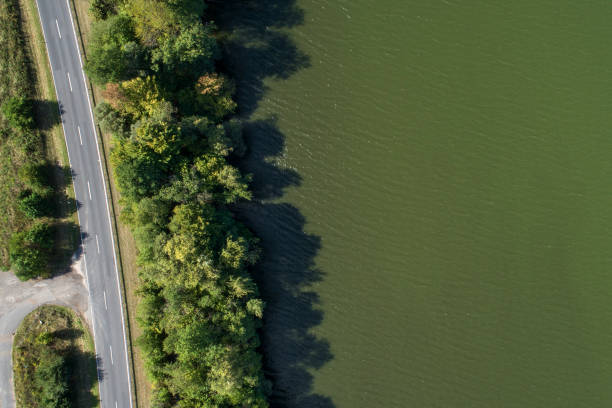 istock Road at the lakeside - aerial view 1036020550