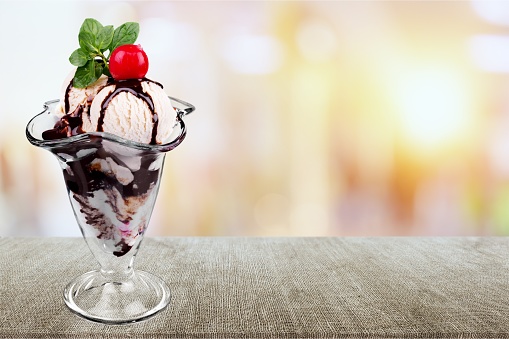 Ice cream with chocolate sauce on desk