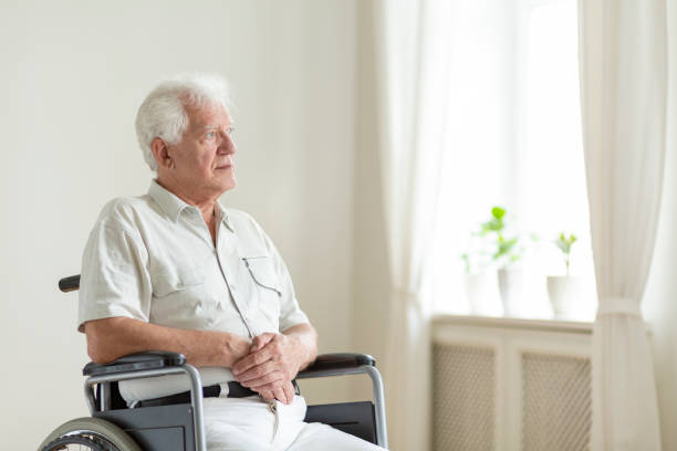 istock Paralyzed, elderly man in a wheelchair alone in a room 1036030234