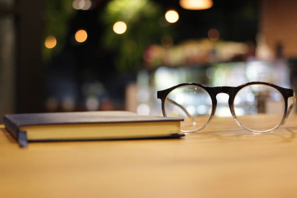 istock closeup glasses and notebook at coffee cafe. reading and working concept. selective focus. 1036030420