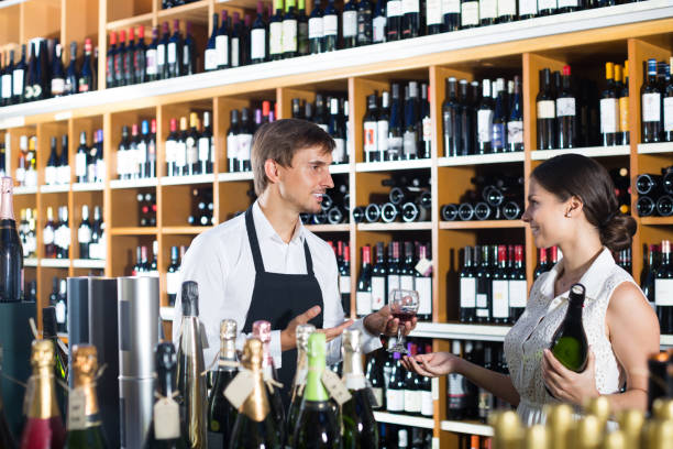 istock wine seller and customer in wine shop 1036030860