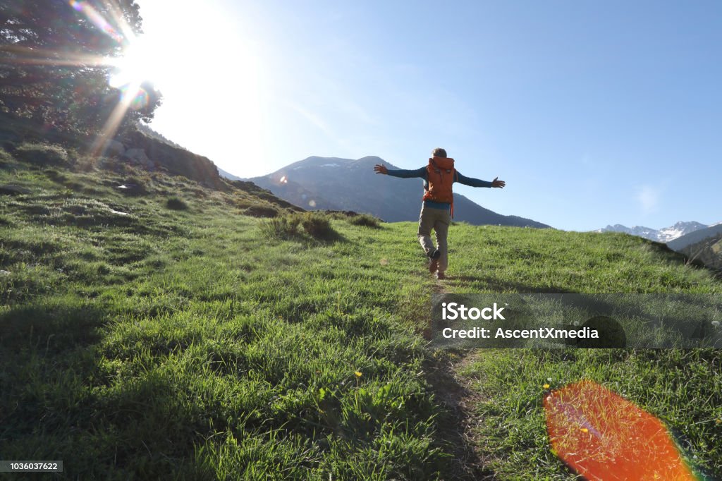 Man walks along pathway in celebratory mood Man walks freely along pathway in the mountains of Andorra Andorra Stock Photo