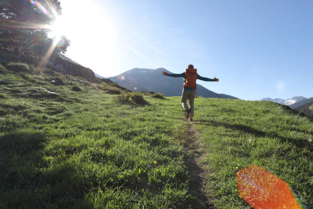 Man walks along pathway in celebratory mood Man walks freely along pathway in the mountains of Andorra andorra photos stock pictures, royalty-free photos & images