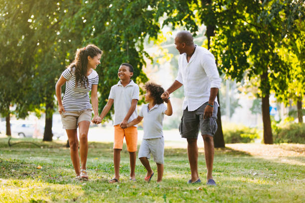 istock Happy couple spending time with their sons in park 1036040058