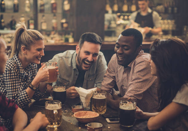 istock Cheerful friends talking during their night out in a pub. 1036041542