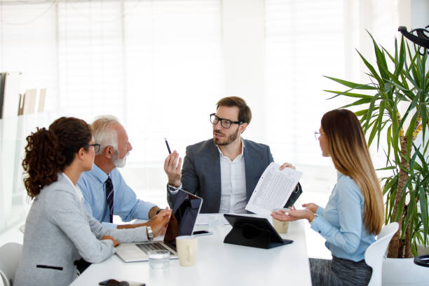 istock Business people having board meeting in modern office 1036044826