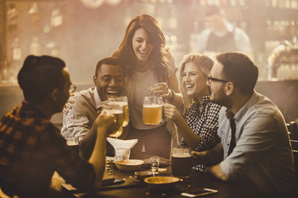 istock Young cheerful friends toasting and having fun together in a bar. 1036045356
