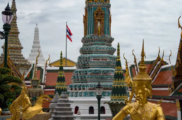 Colorful temples, statues and stupas of the Grand palace in Bangkok, Thailand with a blurry foreground