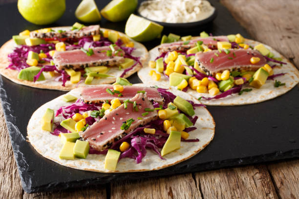 Tacos with tuna steak and fresh vegetables close-up. horizontal