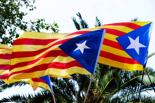some estelada, the catalan pro-independence flag, against the sky
