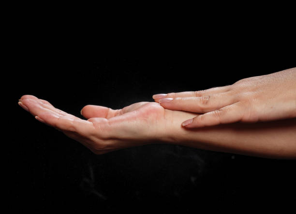 istock Woman holding palm open isolated on black 1036063198