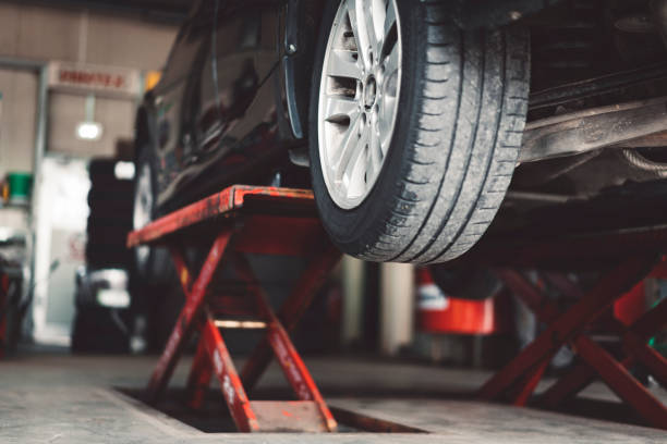 Car lifting Car lifting in a vulcaniser shop repair garage stock pictures, royalty-free photos & images