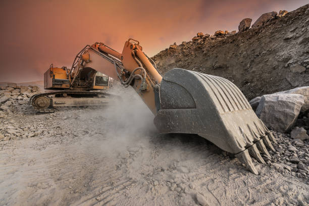 istock Large excavator extracting stone in a dust cloud in a desert 1036069024