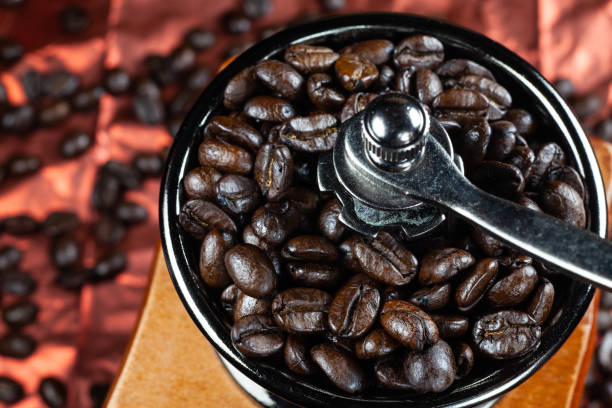 istock Coffee beans and vintage wooden grinder. 1036071090