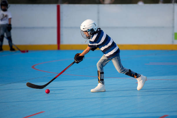 istock Children playing hockey ball on playground 1036076244