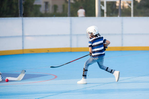 istock Children playing hockeyball on playground 1036076270