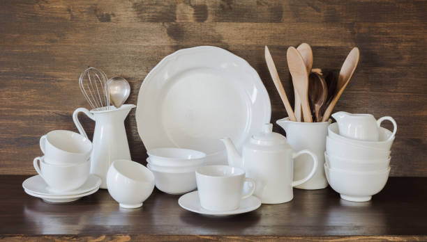 istock Crockery, clayware, white utensils and other different stuff on wooden tabletop. Kitchen still life as background for design. Copy space. 1036078998