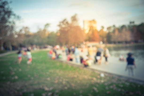 istock Blurry background lakeside park with kids running and people resting 1036089196