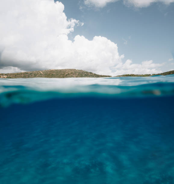 istock Split Photo Half Underwater with Clear Blue Sky and Mountains in Sardinia 1036089410