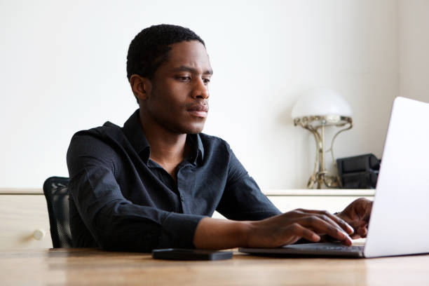 istock young african american man working on laptop at home 1036091710