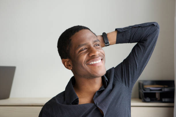 istock happy young african man smiling with hand behind head 1036091744