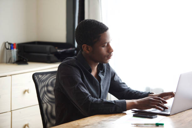istock young african american businessman working on laptop computer in office 1036091750