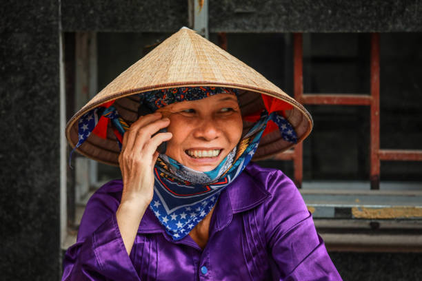 Hanoi, Vietnam-August 27, 2018 : Vietnamese woman taking on moblie phone on street in Hanoi, Vietnam
