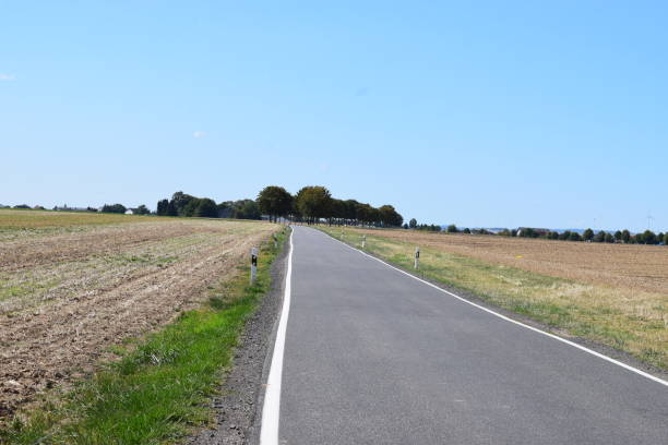 istock country road in autumn, Eifel region 1036092114