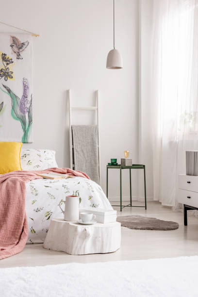 istock A cozy fresh bedroom interior in white with a bed dressed in sheets, pillows and blanket. Real photo. 1036098360