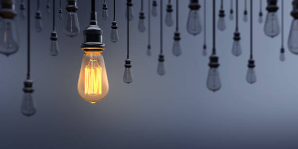 Glowing Light Bulb Standing Out From the Crowd Glowing Light Bulb between the others on dark background. Can be used leadership, innovation and individuality concepts.  (3d render) changing focus stock pictures, royalty-free photos & images