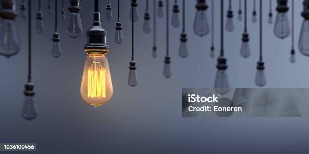 Glowing Light Bulb Standing Out From The Crowd Stock Photo - Download Image Now - Light Bulb, Concepts, Change