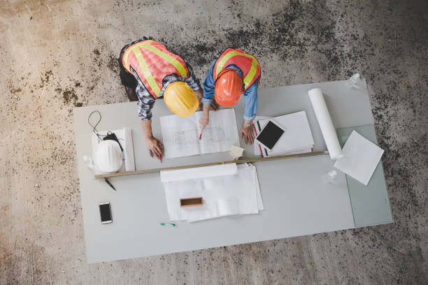 istock Top view of architects and engineers to help create a blueprint to build a modern building. 1036102708