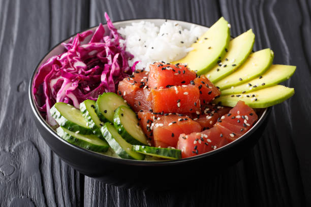 istock Organic food: tuna poke bowl with rice, fresh cucumbers, red cabbage and avocado close-up. horizontal 1036102776