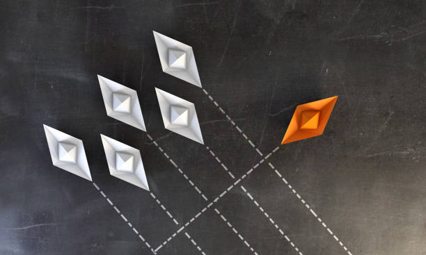 istock Paper Boats On Blackboard - Standing Out From the Crowd 1036106326
