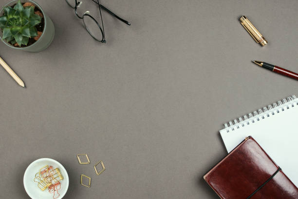 istock Stylish minimalist mockup with notebook, planner, glasses and pen on grey background on copyspace 1036106530