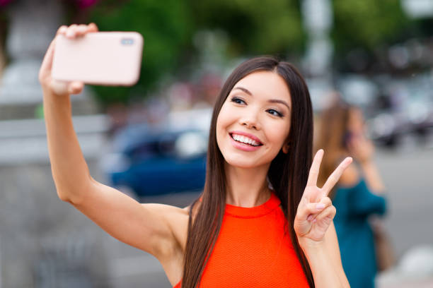istock Charming brunette girl making selfie on her pink smartphone and 1036106622