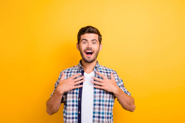 istock I won?! Young brunette man with an enthusiastic face look into t 1036106794